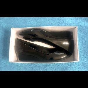 Candra Wedge Pump by Bandolino. It has a simple finish and Iconic peep toes.